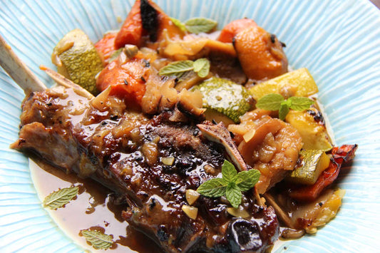 Braised goat shoulder chop with cinnamon and blood orange glaze