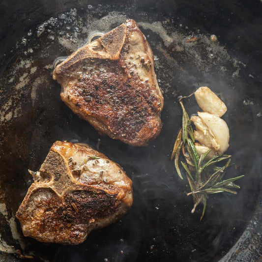 Pan seared goat loin chops with rosemary crust, showcasing a golden brown exterior