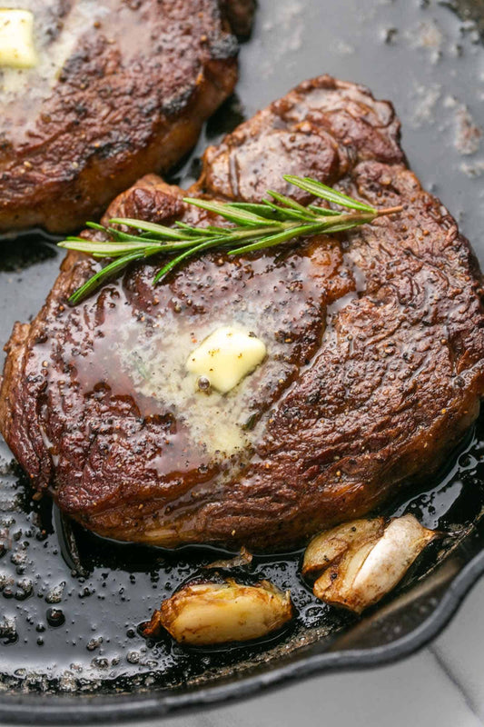 Pan seared sirloin steak topped with garlic butter and fresh herbs