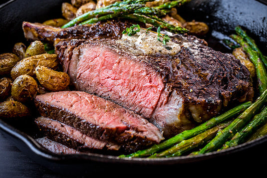Juicy cowboy rib steak with a perfect sear, showcasing rich marbeling.